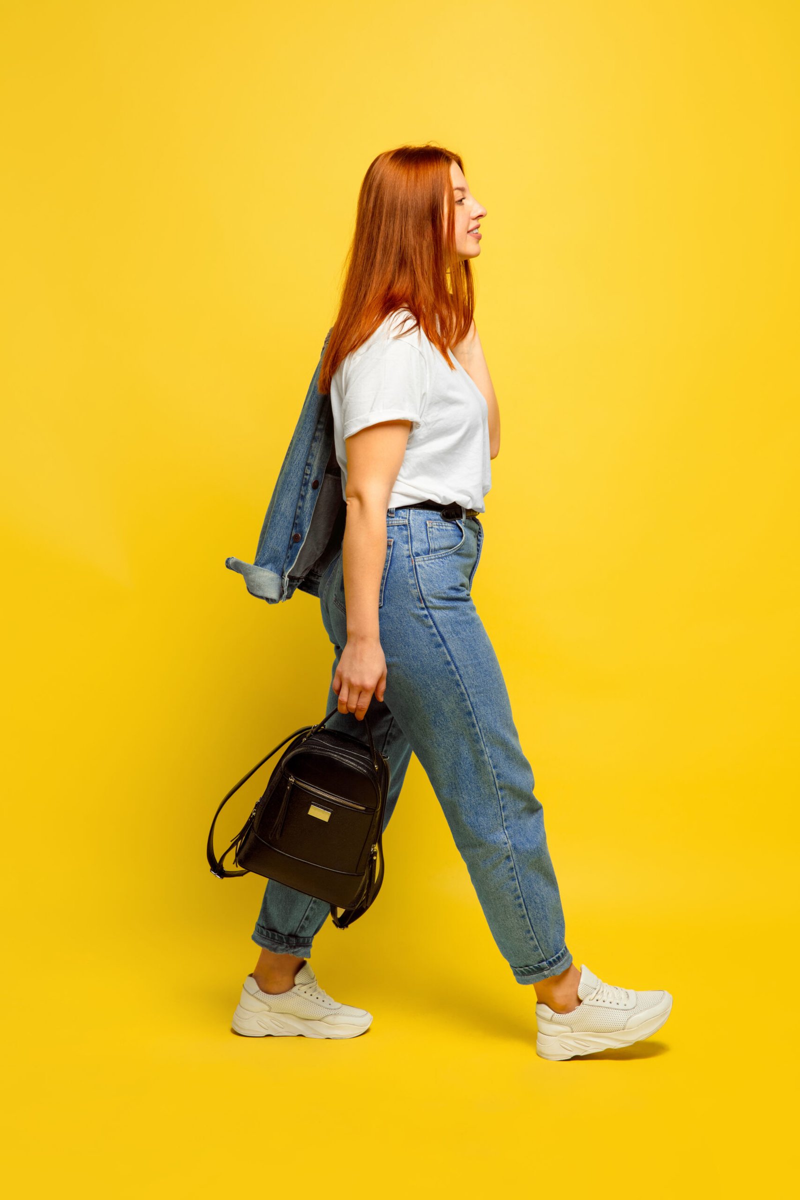 It's easier to be follower. Need minimum clothes to go. Caucasian woman's portrait on yellow background. Beautiful female red hair model. Concept of human emotions, facial expression, sales, ad.